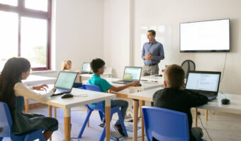 Confident teacher explaining lesson to pupils
